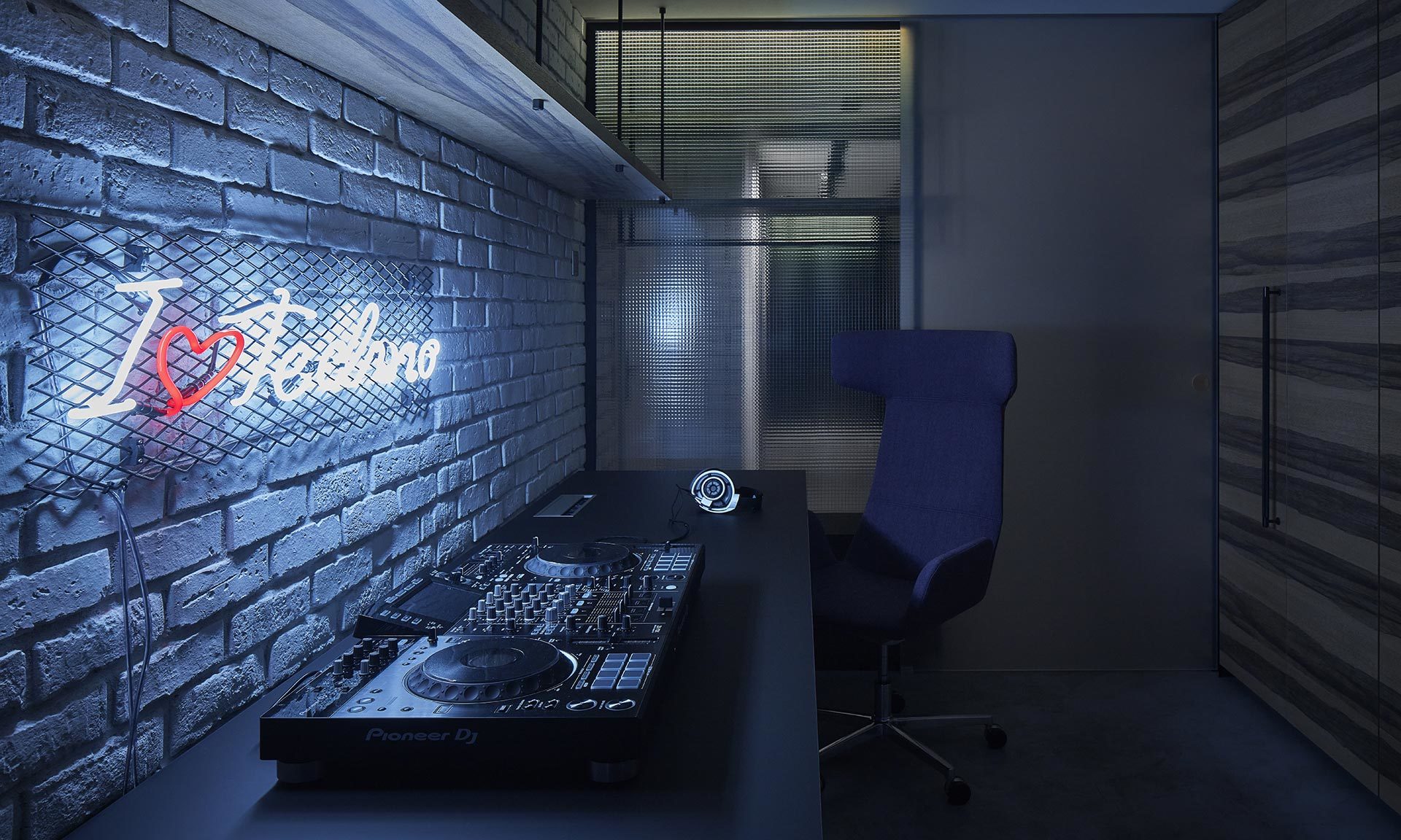 Pražský byt pro technaře má temný interiér s&nbsp;DJským pultem a&nbsp;taneční terasou